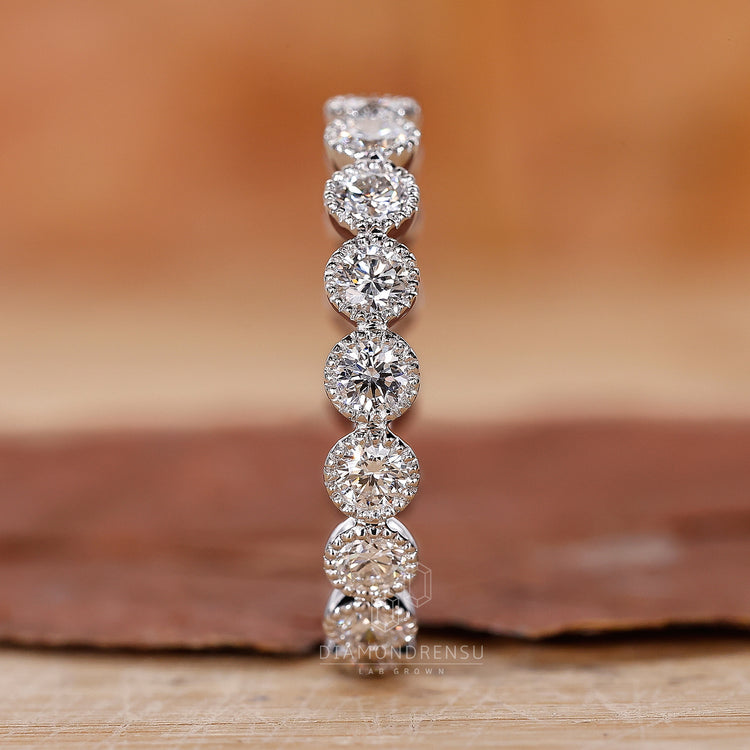 Lab diamond eternity band with milgrain detailing.