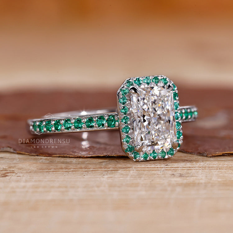 UK engagement ring with radiant centre and claw prongs.