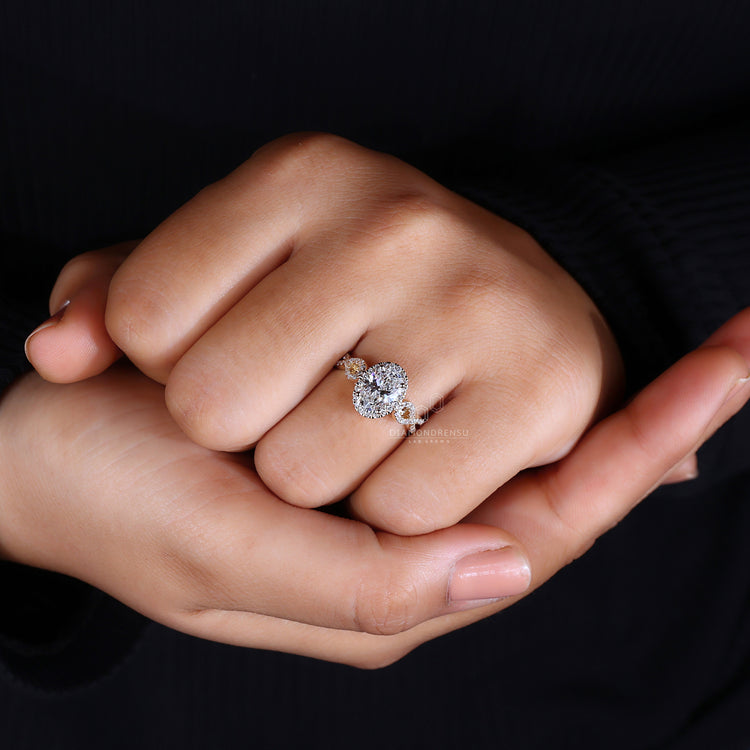 Oval diamond center stone with halo setting.