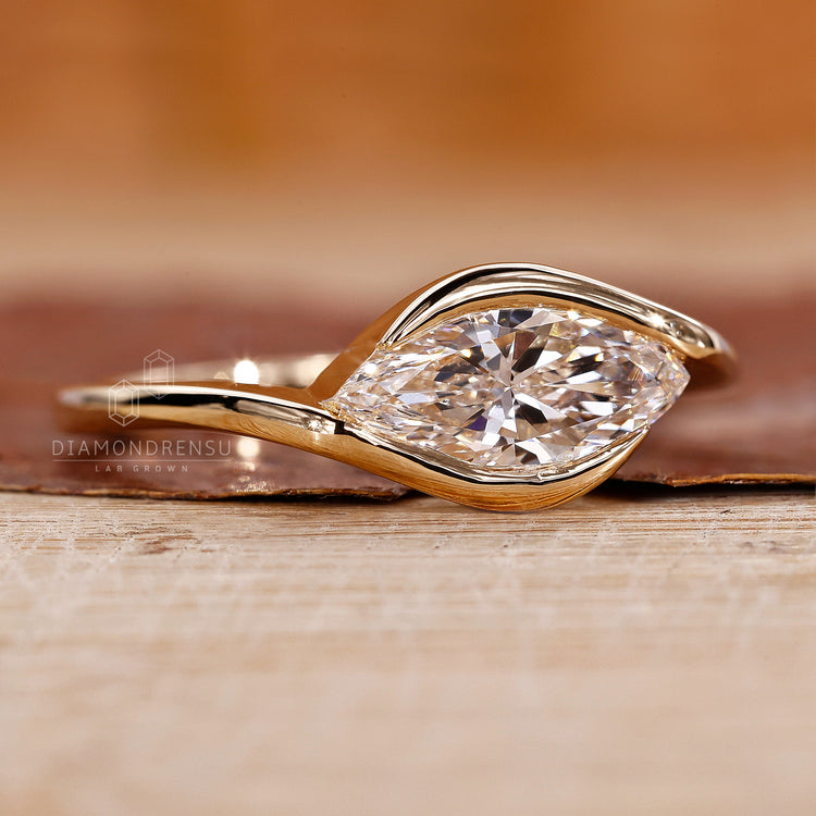 Solitaire setting marquise diamond ring handmade in yellow gold.