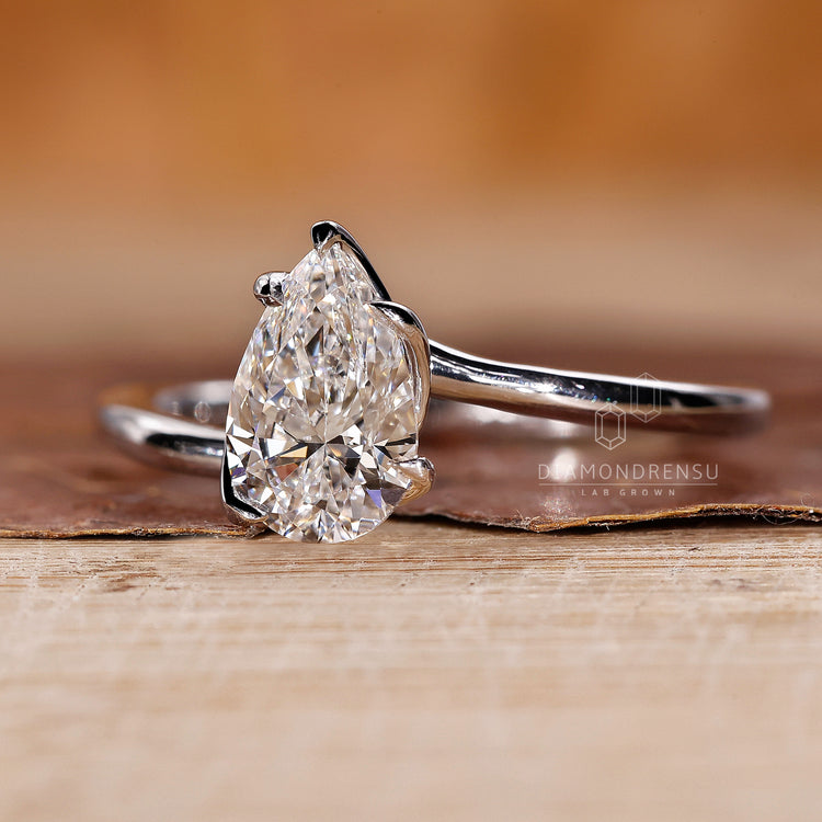 Handmade ring with lab grown pear diamond and prong setting.