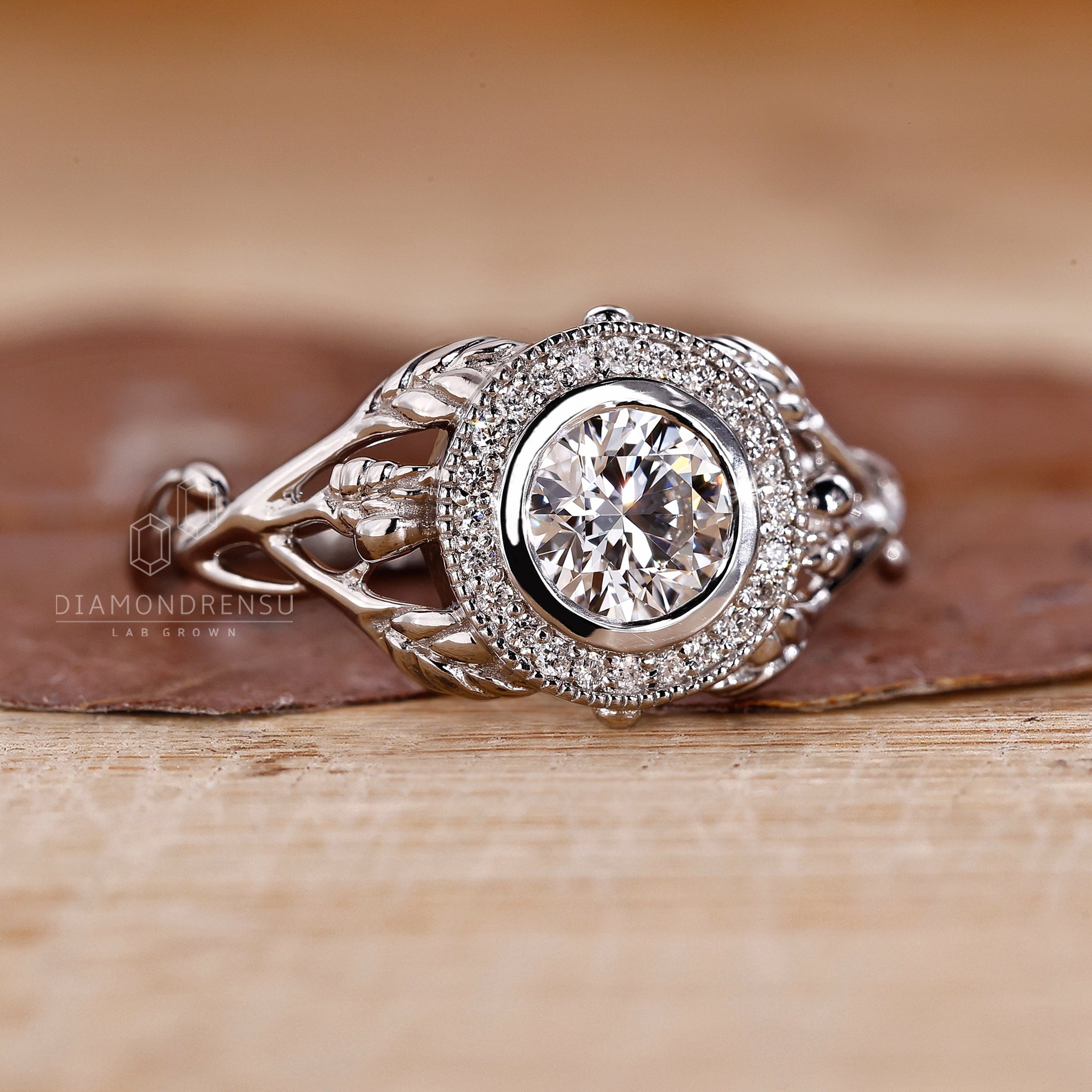Round diamond white gold ring in bezel setting ring finish.