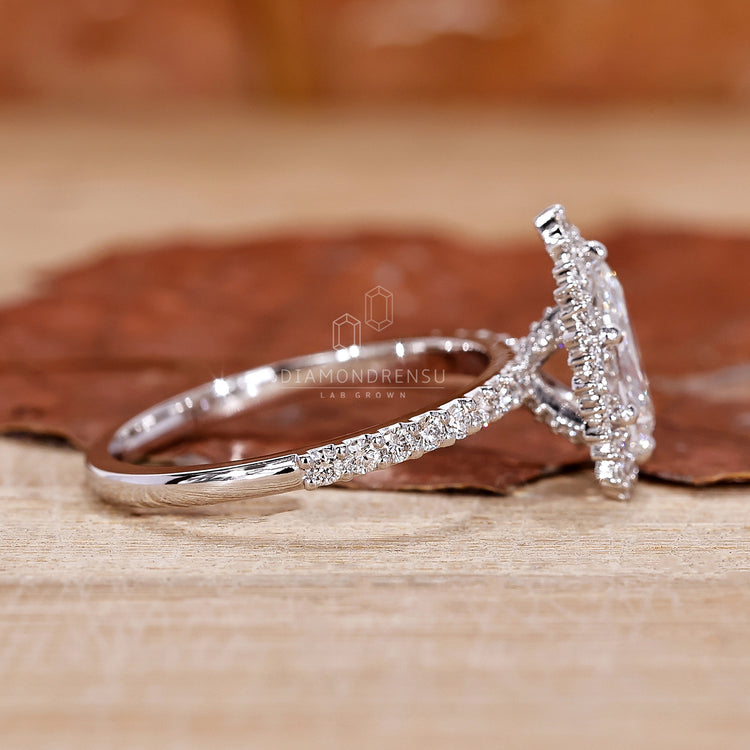 Handmade ring with round cut diamond and halo detail.