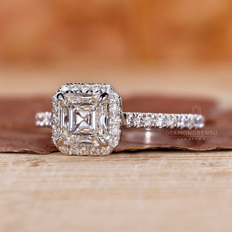 Halo ring with an asscher cut diamond and a cathedral setting, perfect as a diamond ring UK.