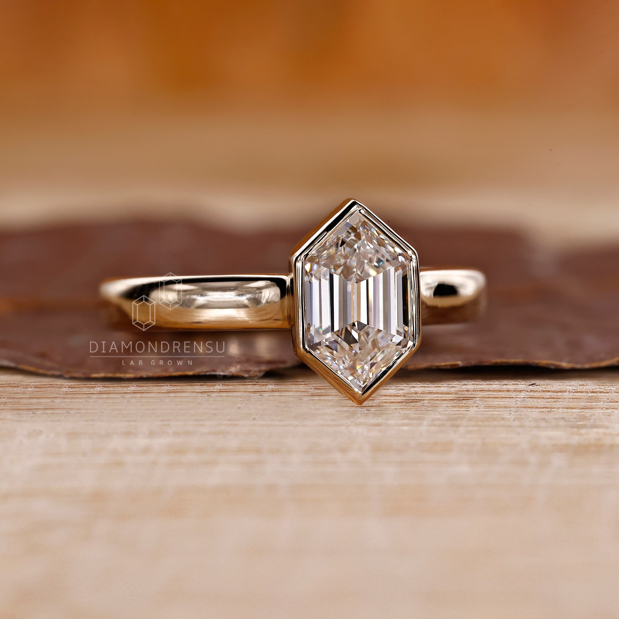 Bezel solitaire ring in yellow gold.