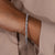 Close-up of diamond bangle bracelet with tab prongs Close-up of diamond bangle bracelet with tab prongs