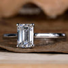Elegant emerald cut diamond ring with sparkling finish.