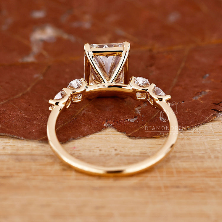 Unique engagement ring includes radiant cut and oval diamond.