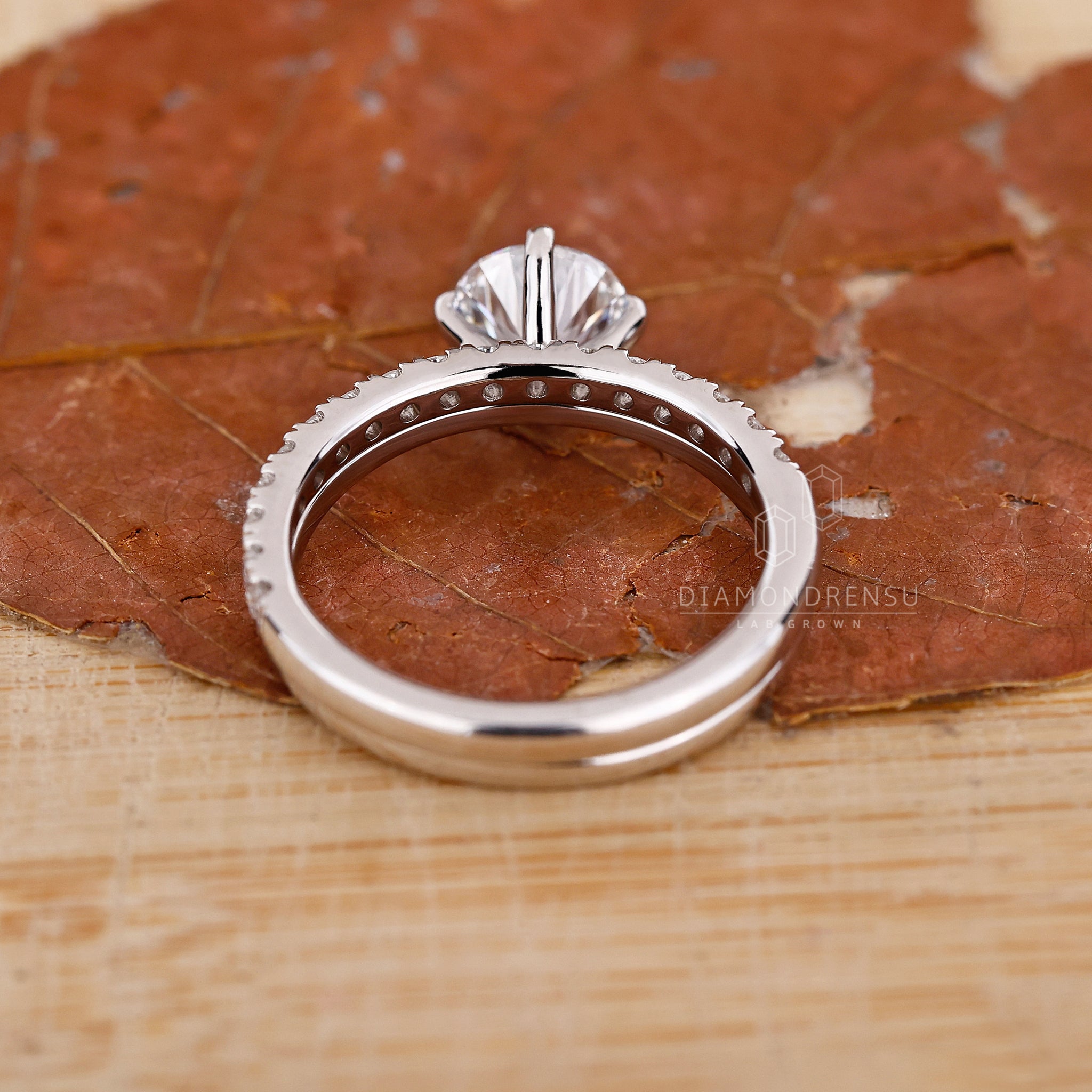Compass prong setting on solitaire ring with perfect symmetry.