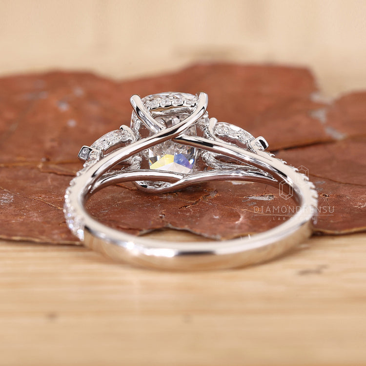 Side stone engagement ring with prong setting
