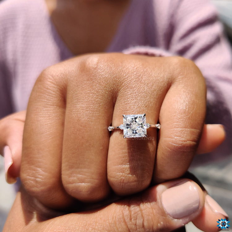Distance pave ring featuring radiant moissanite and round cut pave band.