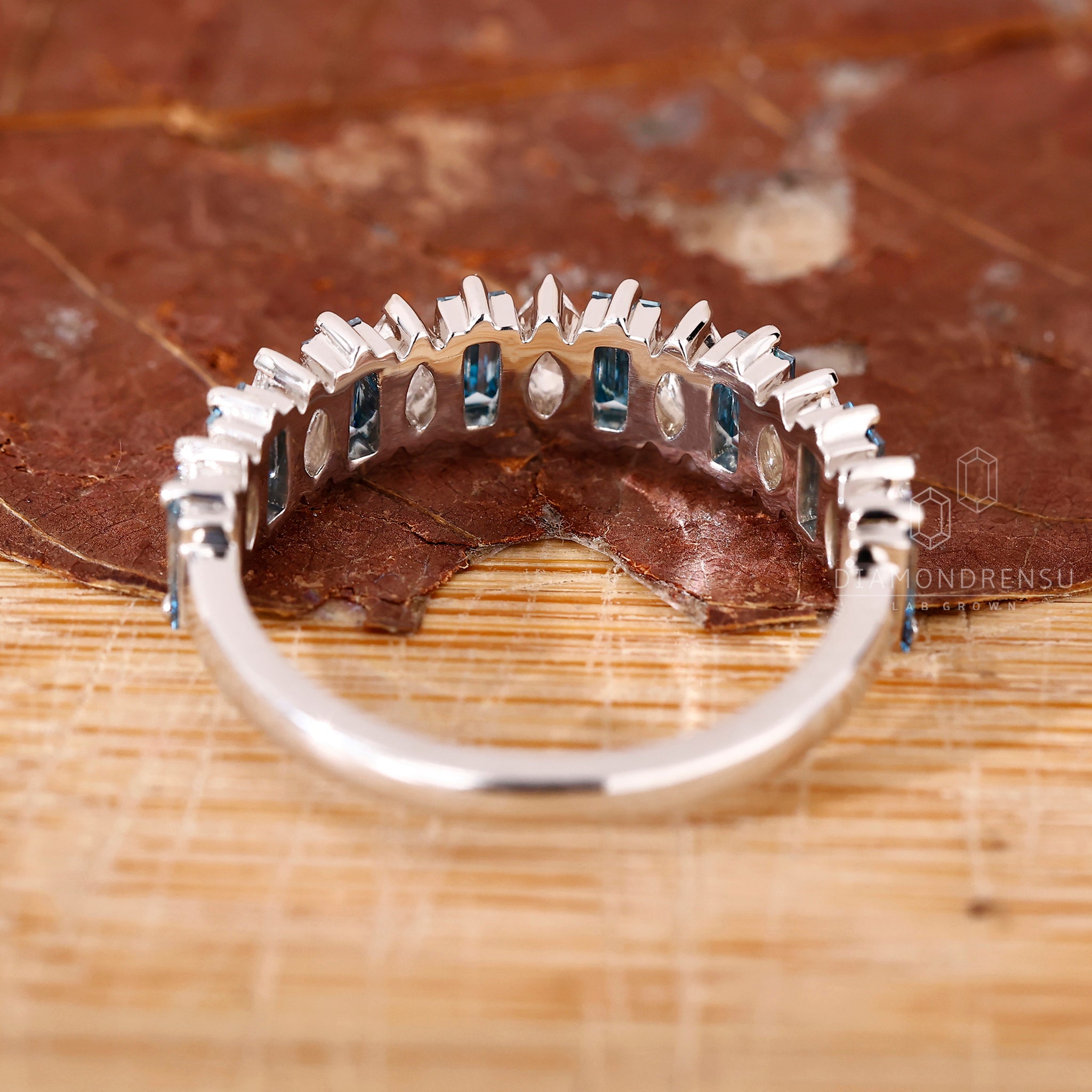 Handmade jewellery with a half eternity white gold band and mixed diamonds.