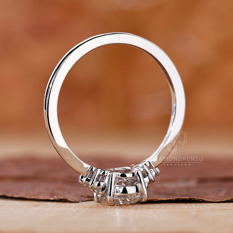 Prong setting ring with oval cut engagement stone and white gold band.