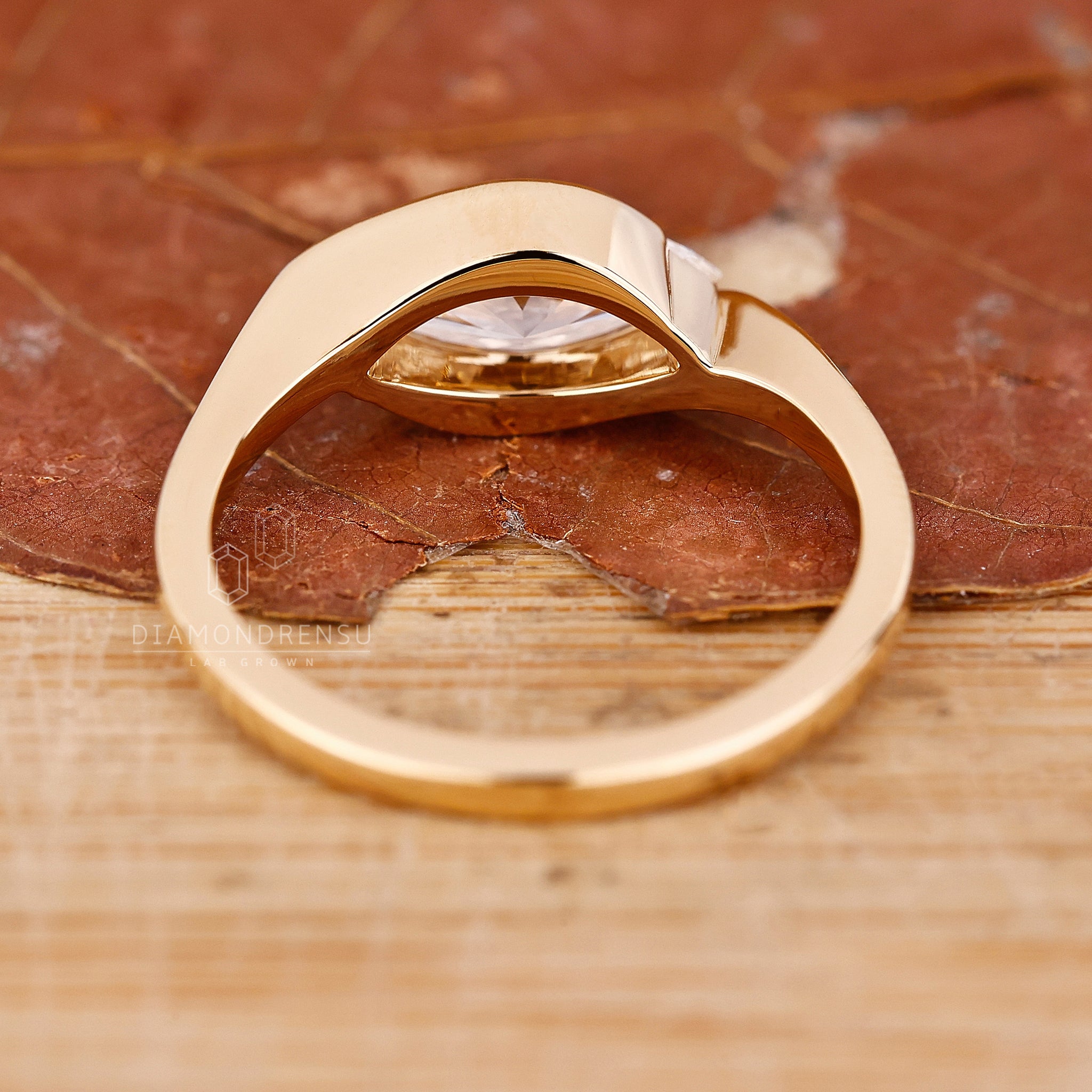 Yellow gold engagement ring with handmade east west diamond setting.