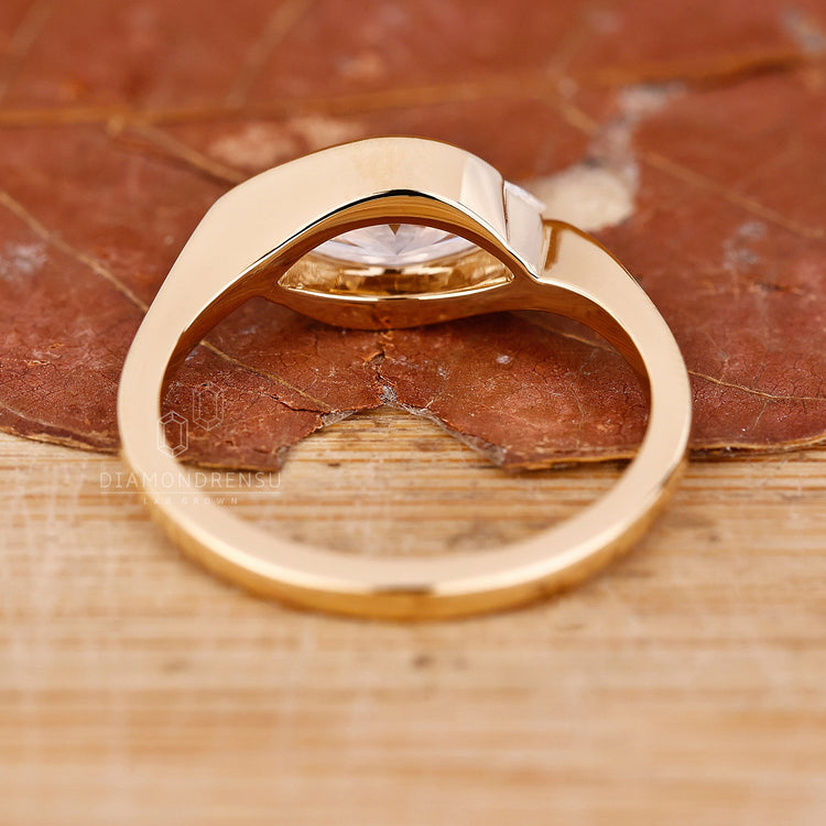 Yellow gold engagement ring with handmade east west diamond setting.