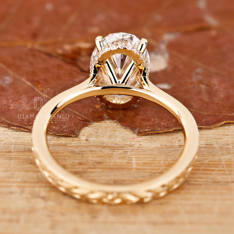 Handmade jewellery ring featuring round cut emerald gemstone and claw setting.