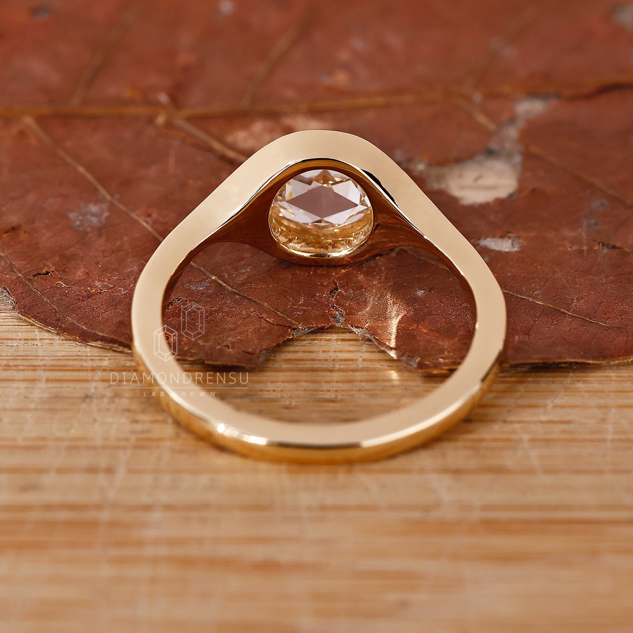 Lab grown diamond ring with rose cut stone and bezel setting.