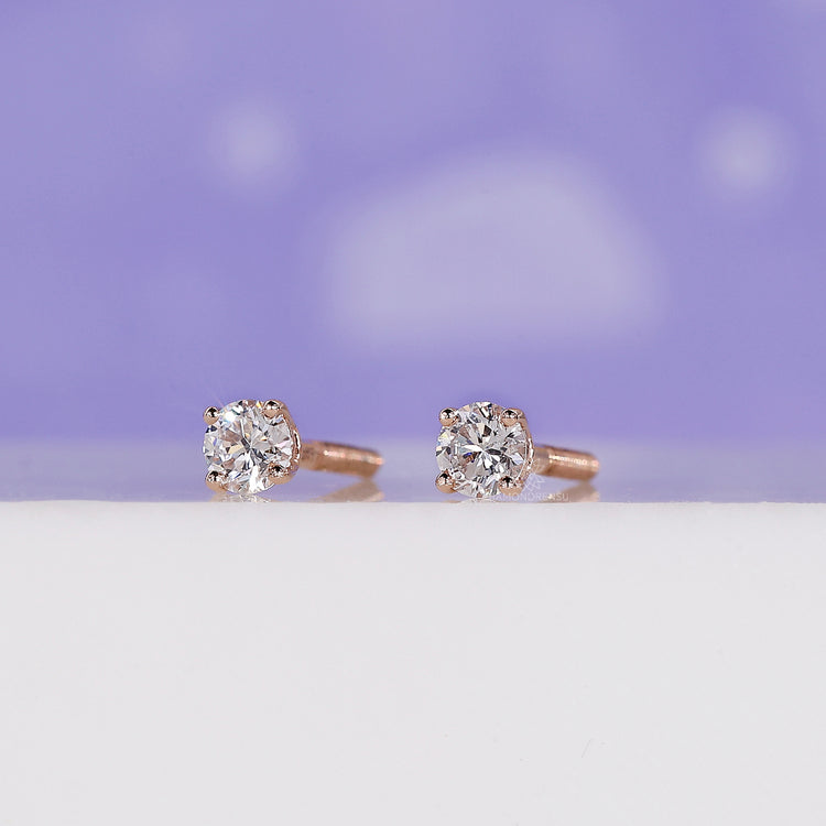 Elegant diamond stud earrings in rose gold.