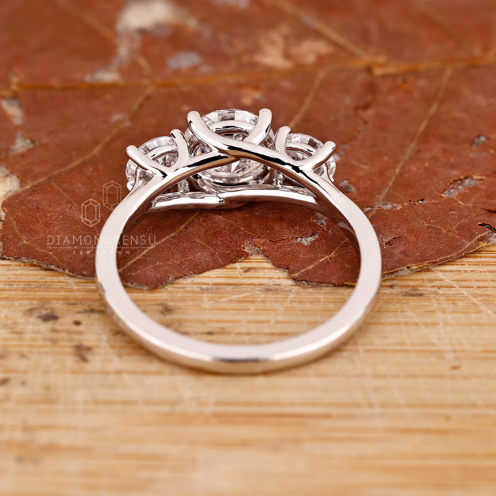 Handmade jewellery ring featuring trellis setting and round diamonds.