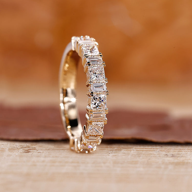 Princess and baguette diamond band crafted in yellow gold with a sleek design.