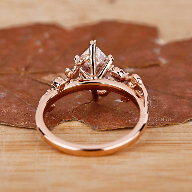 Marquise and Round Side Stone Ring in a rose gold setting.