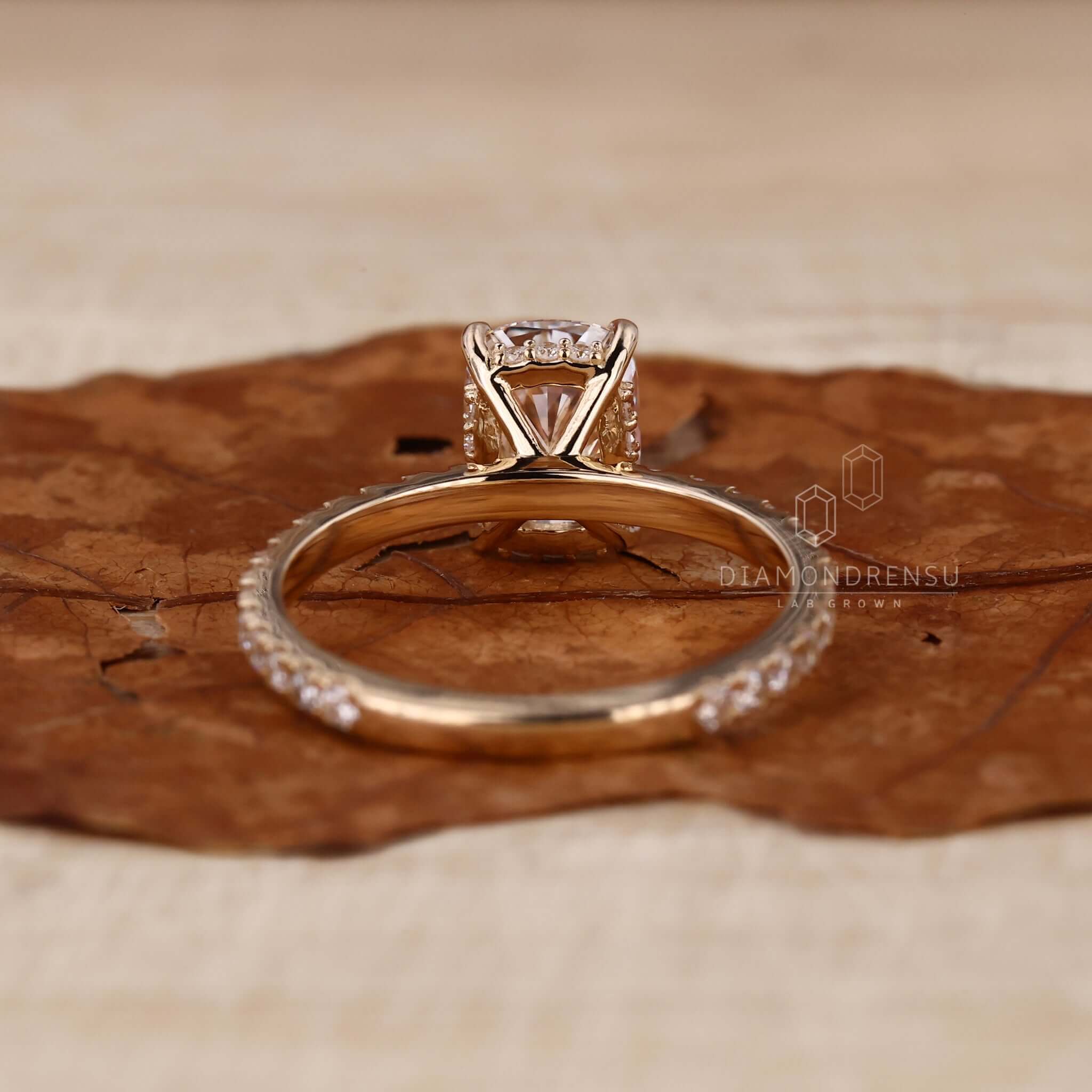 Pave ring setting on an elongated cushion cut engagement ring crafted for timeless beauty.