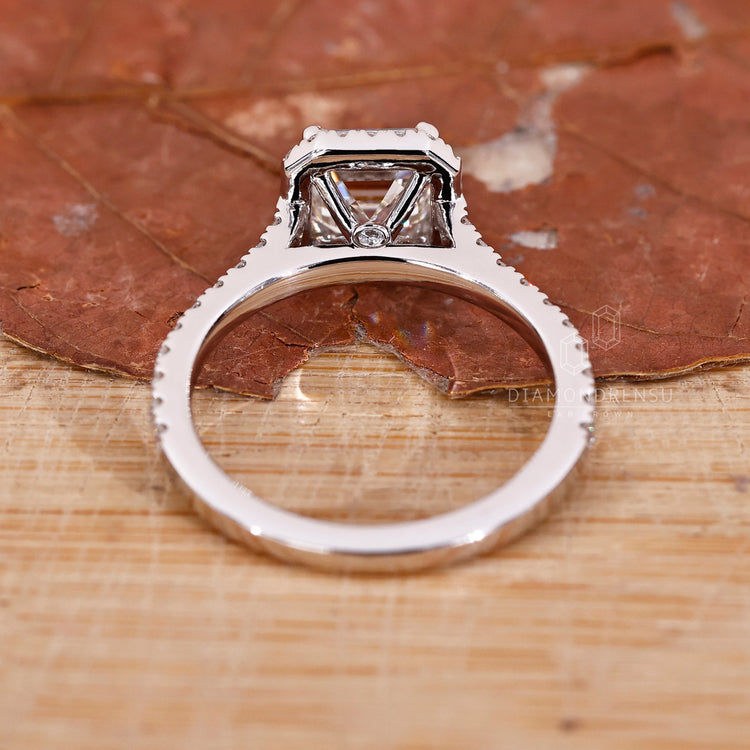 Asscher cut diamond with a pave diamond design, crafted as an elegant engagement ring for women.