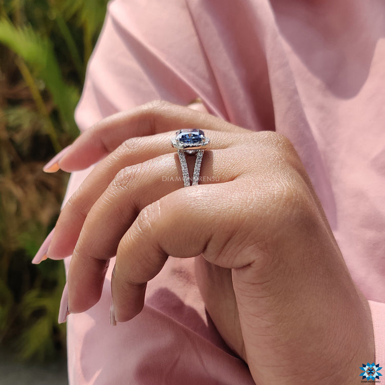 Halo cushion moissanite ring with handcrafted pave split shank and white gold finish.