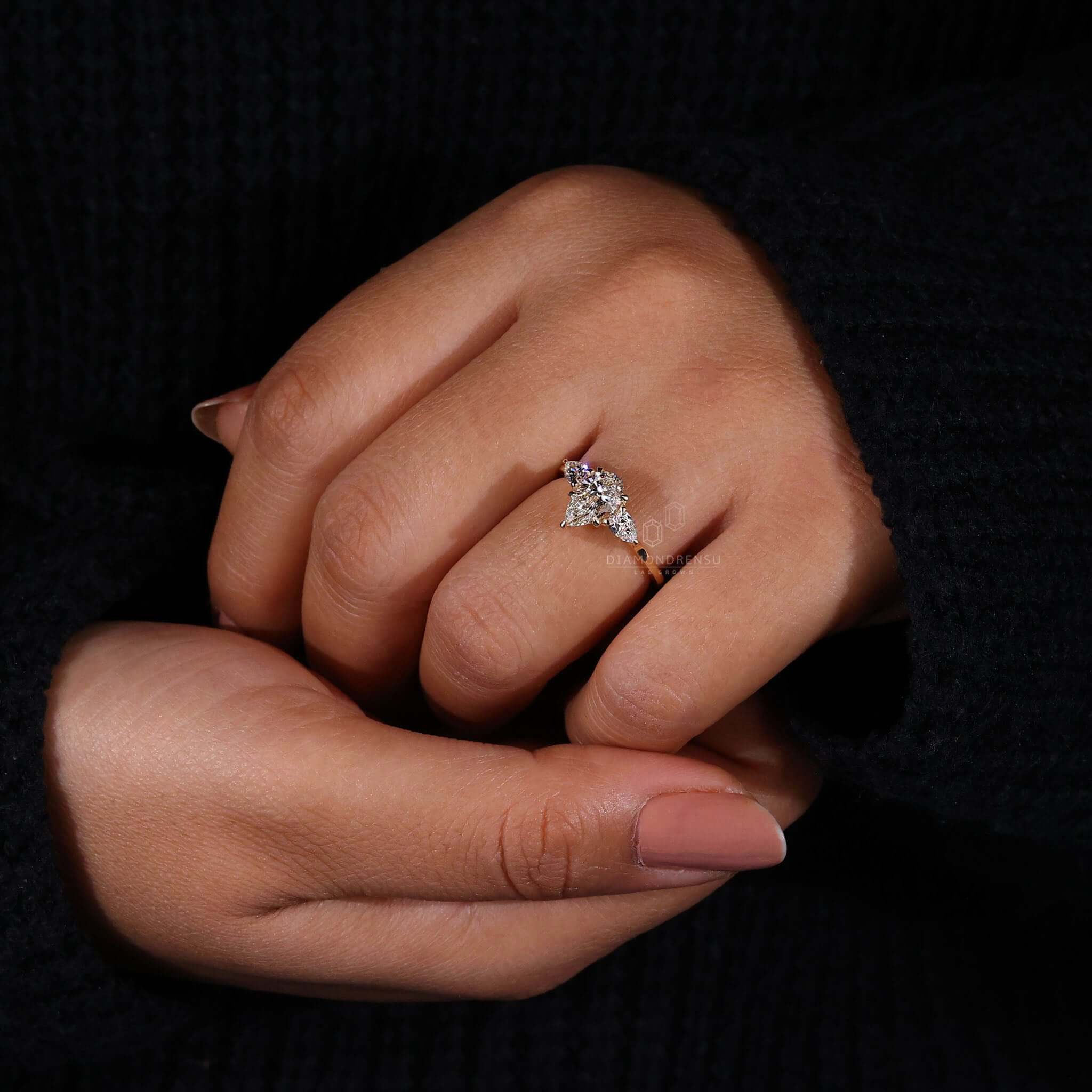 Two Side Stones pear diamond engagement ring in claw prong setting.