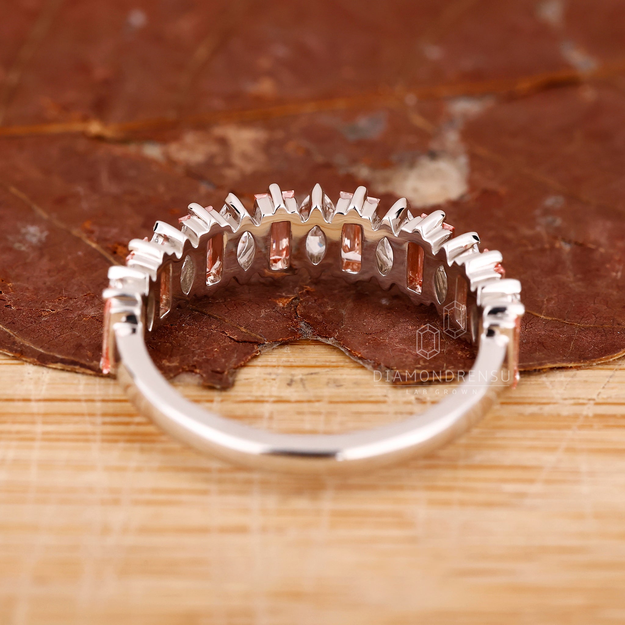 Handmade band in white gold featuring pink baguette diamond accents.