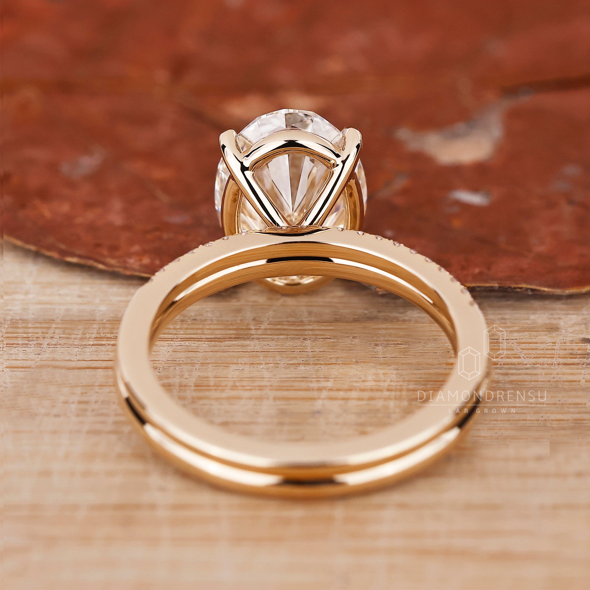 Yellow gold bridal set with oval diamond ring and 4 prong claw setting ring.