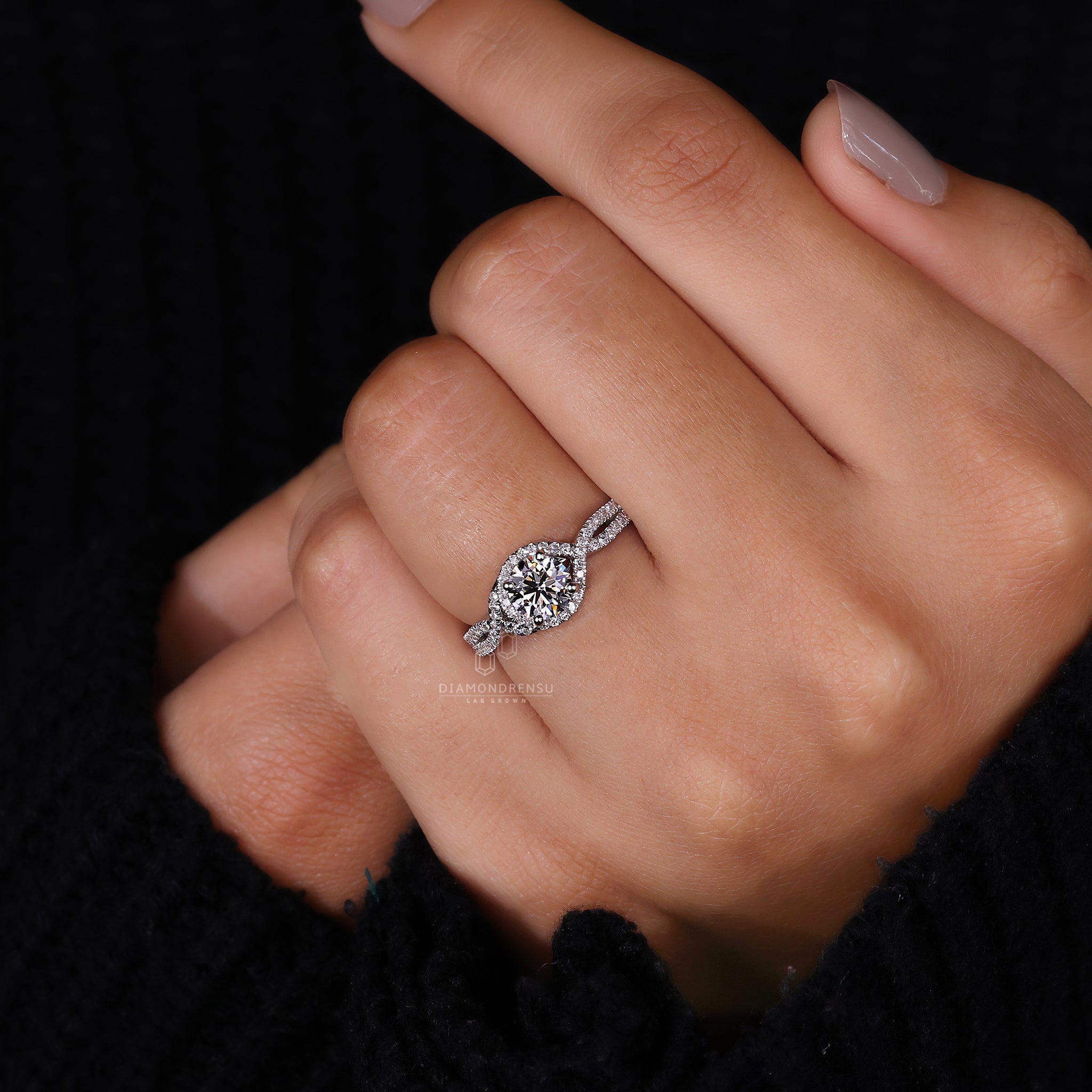 Round cut engagement ring featuring prong setting details.