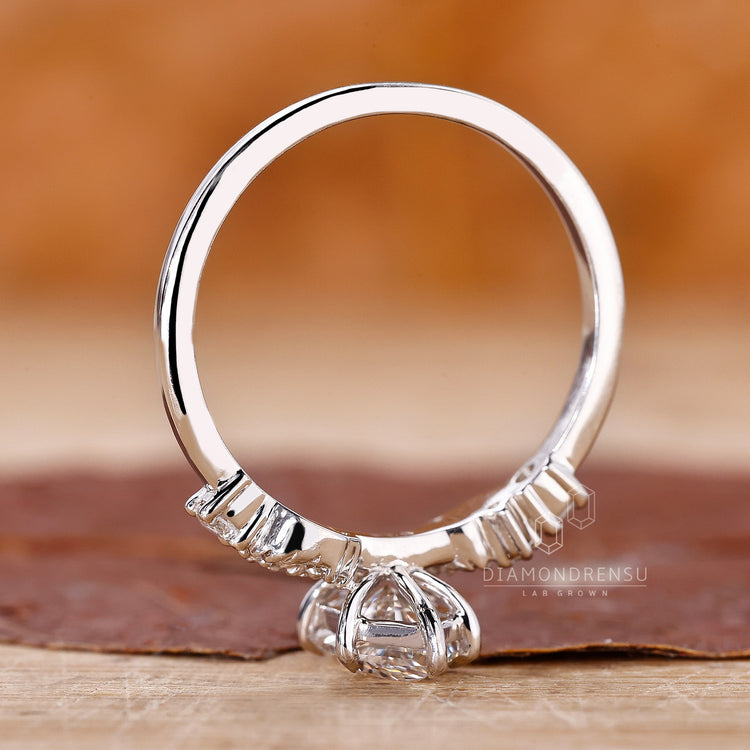 Round side stone ring with custom design and lab grown diamonds.