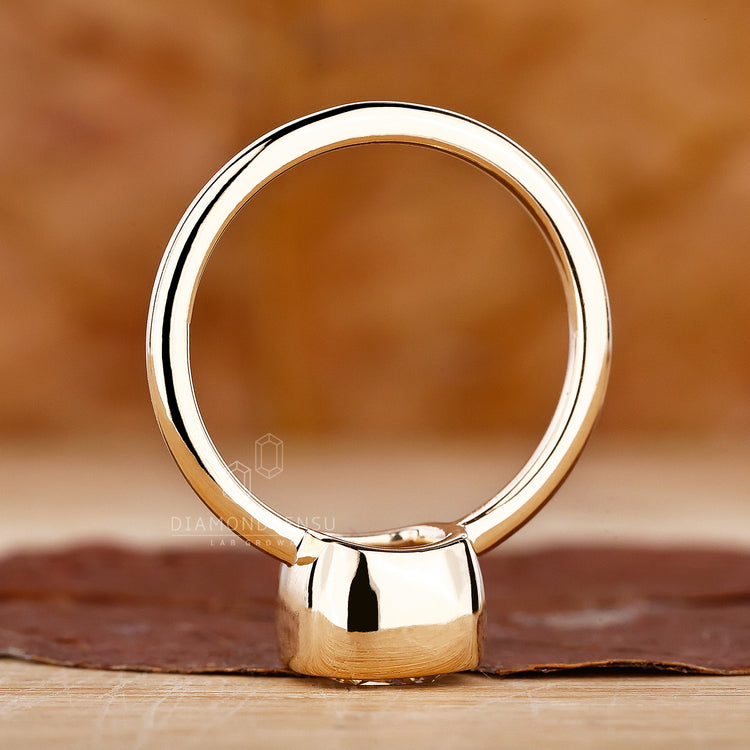 Handmade ring is designed with cushion cut diamond and yellow gold base.