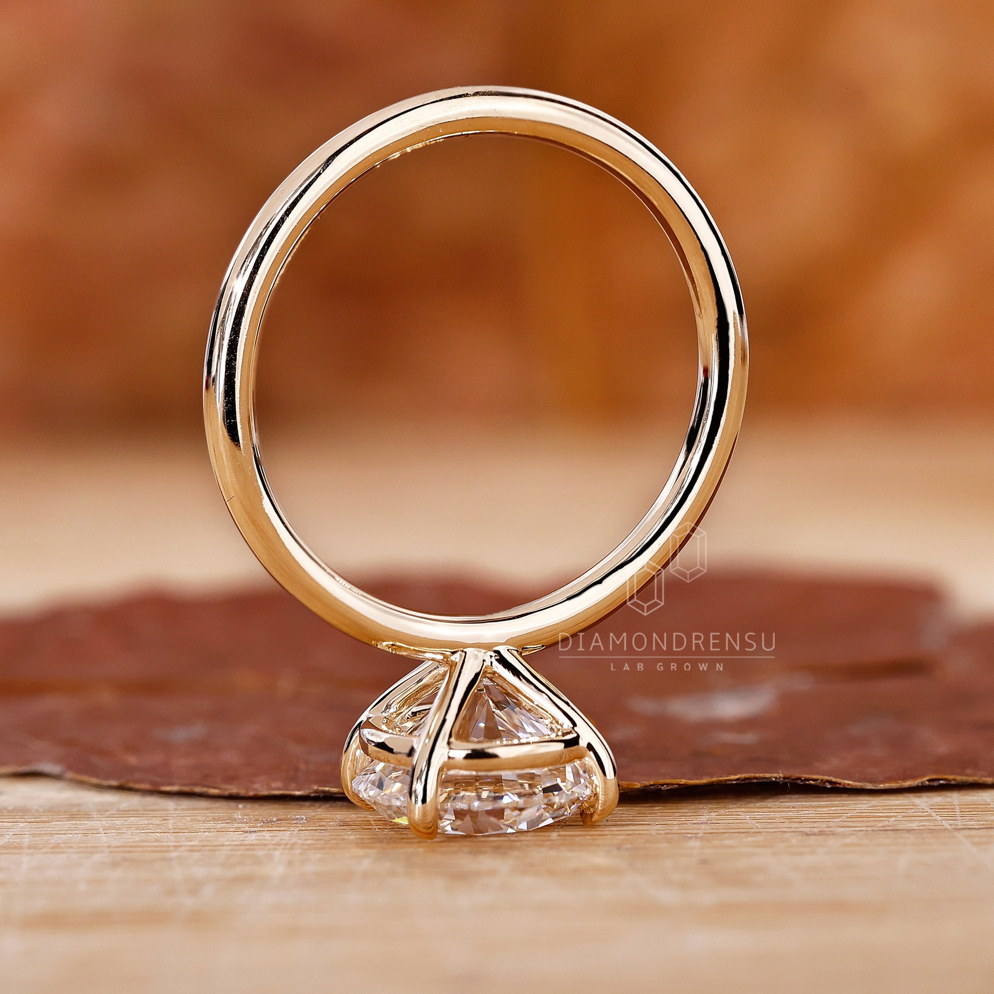 Yellow gold solitaire ring with lab grown round diamond.