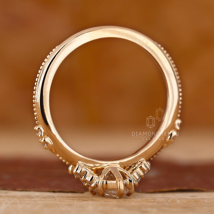 Yellow gold ring with marquise diamond cluster setting.