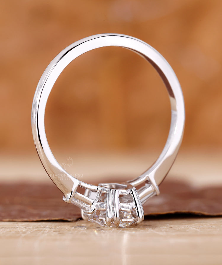 Claw prong setting with tapered baguette side stones.