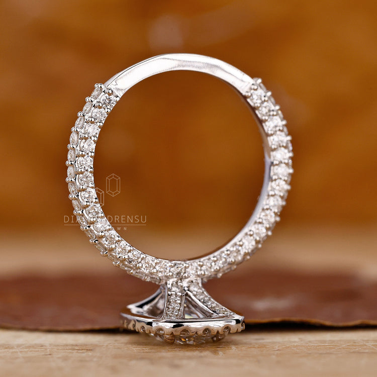 Custom engagement ring with oval diamond and three side pave stones.