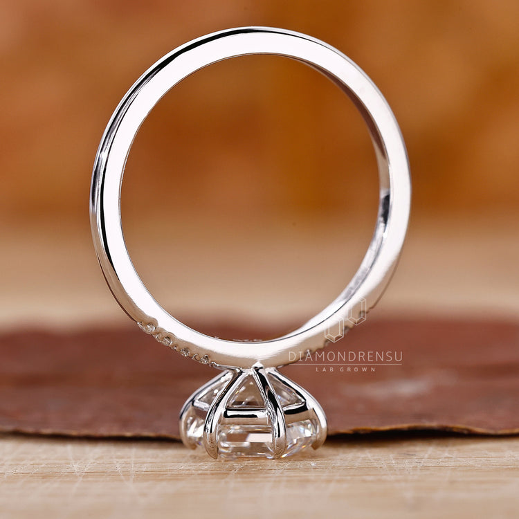 Buy engagement ring featuring round cut side stones.