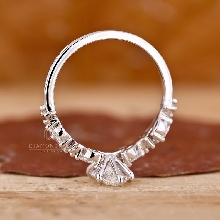 Marquise diamond engagement ring with zigzag pave band in UK style.