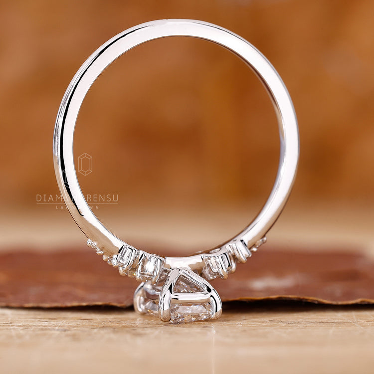 Diamondrensu UK engagement ring with cushion and round diamonds.