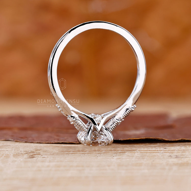 Diamonds London UK ring with Portuguese cut center and custom accents.