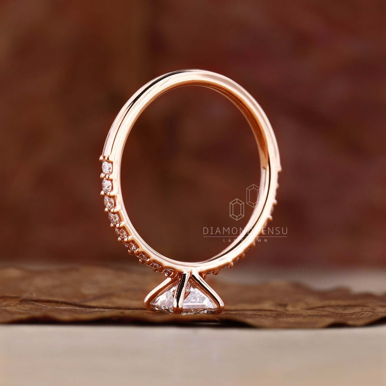 Gold princess cut engagement ring with pave detailing for added sparkle.