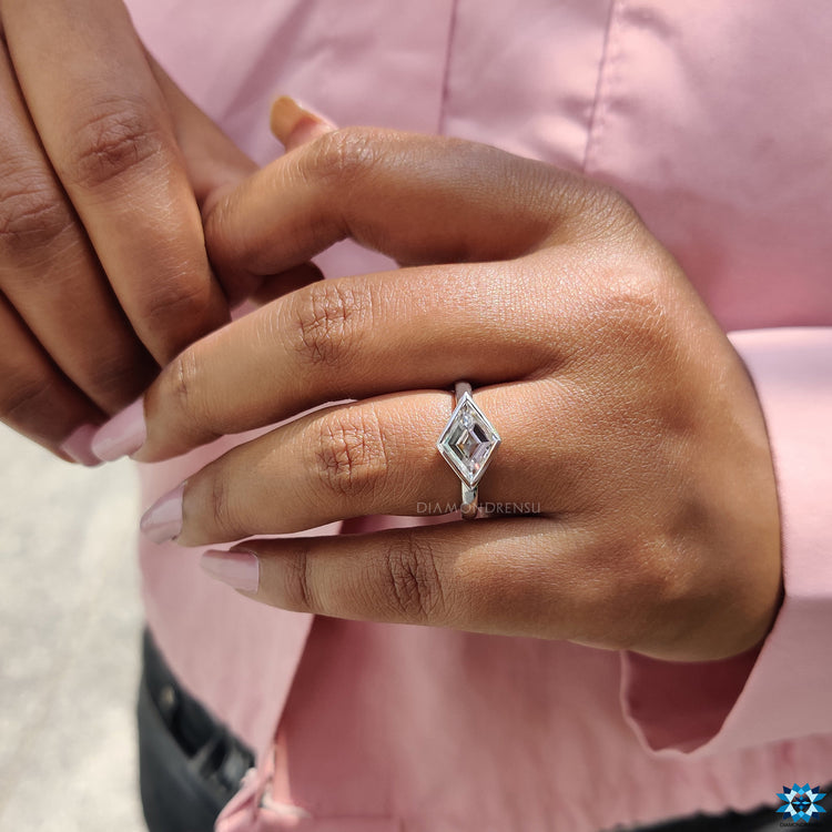 East to west moissanite solitaire ring in white gold.