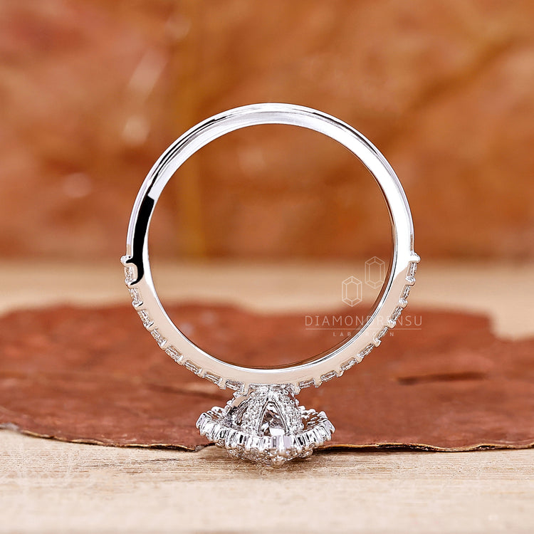 Diamondrensu UK engagement ring with a round cut halo and pave accents.