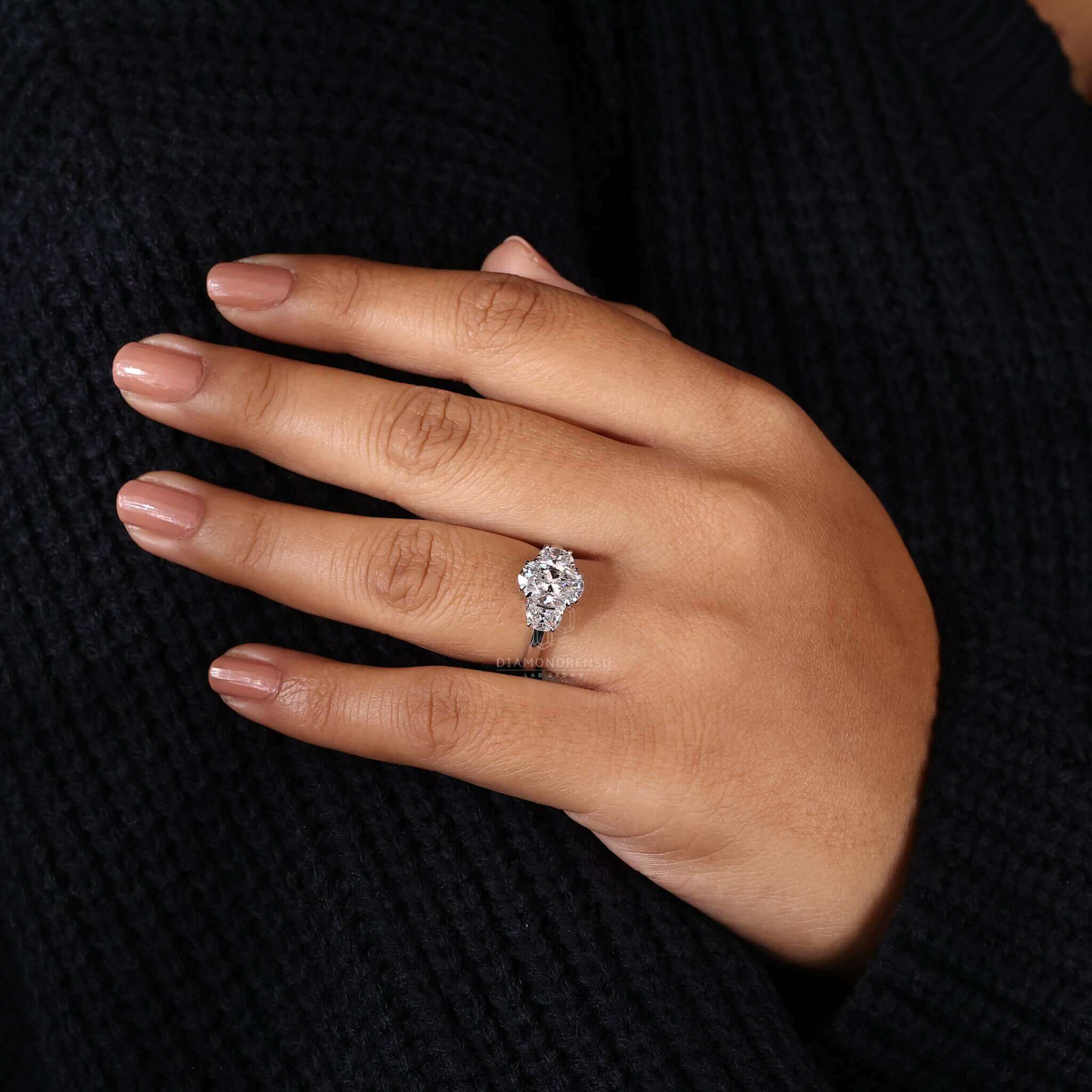 Three stone ring with an oval diamond centre, crafted from Lab Grown Diamond, a perfect engagement ring UK style.