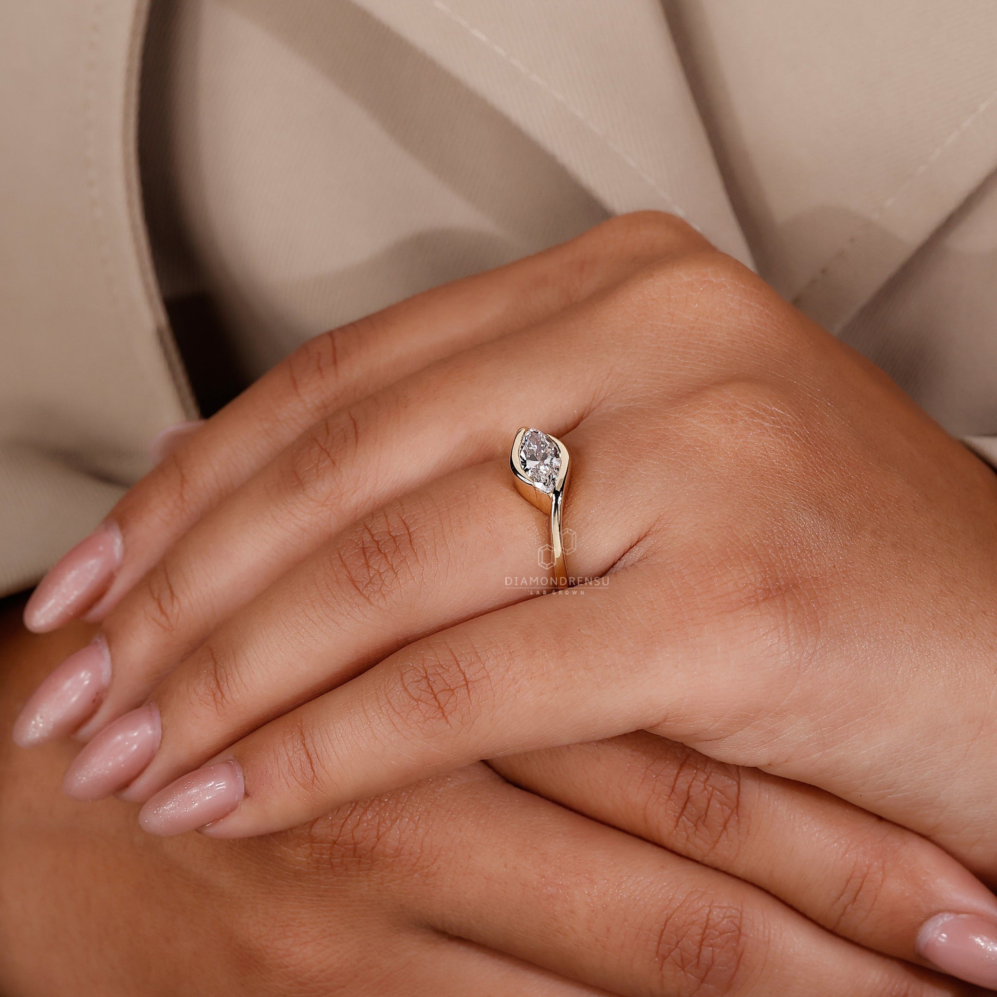 Custom diamond ring in east west style with bezel set marquise diamond.