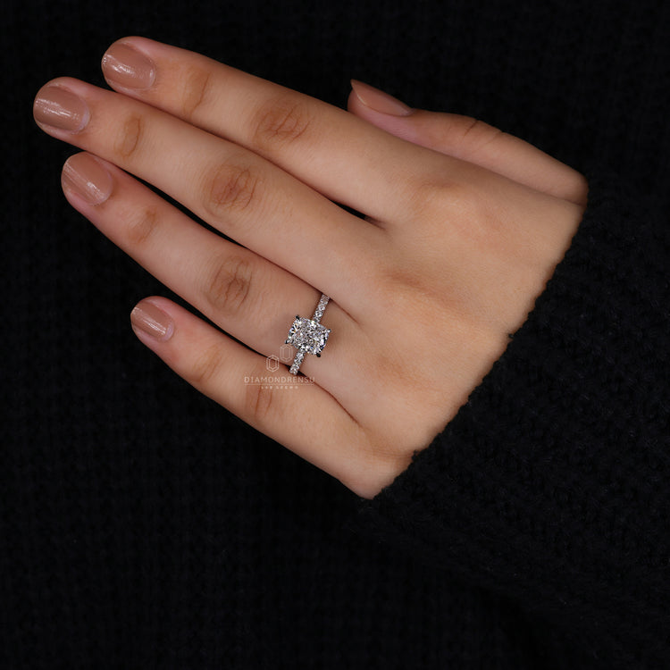 Hidden halo engagement ring with pave diamond ring and cushion centre.