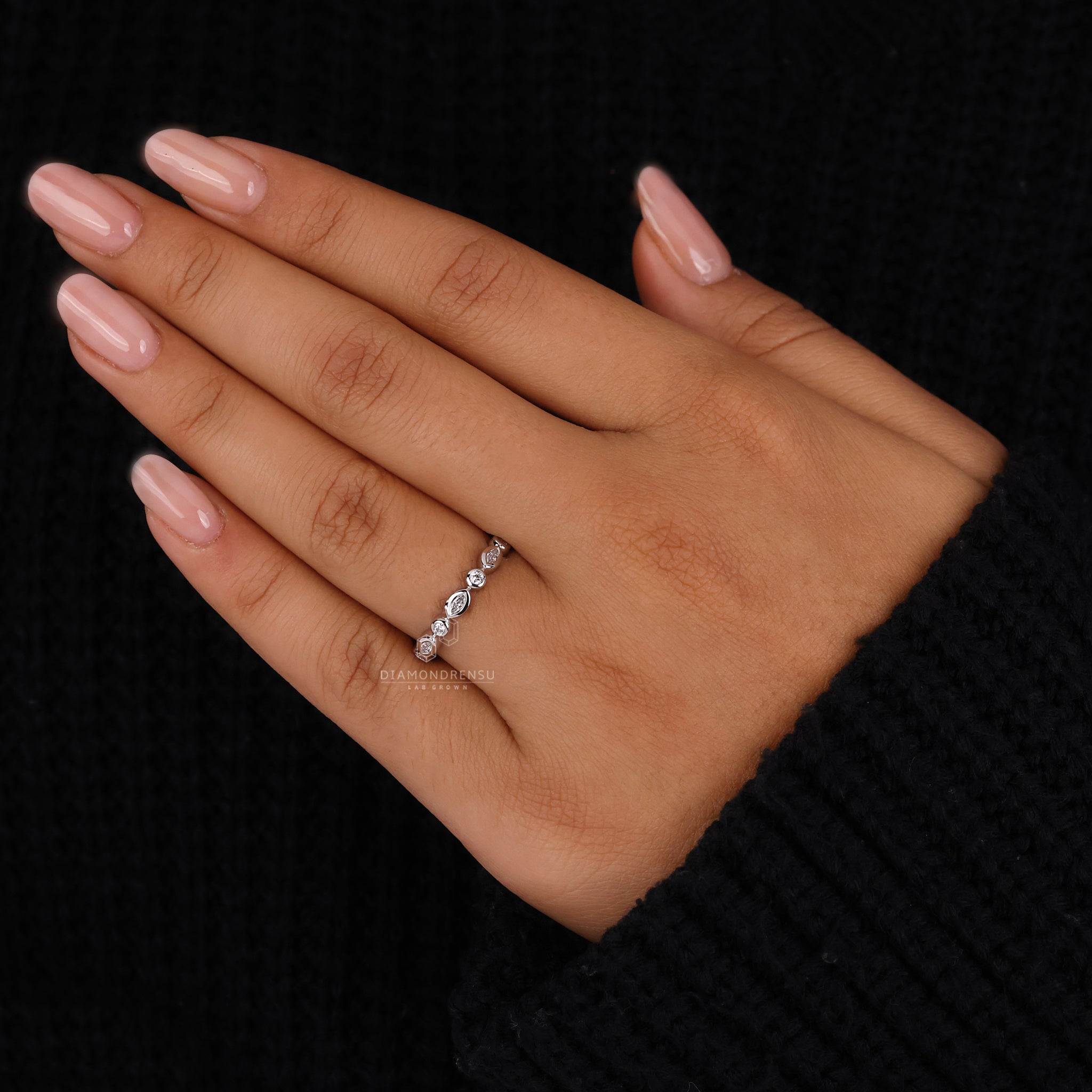 Handmade band showcasing marquise and round diamonds.