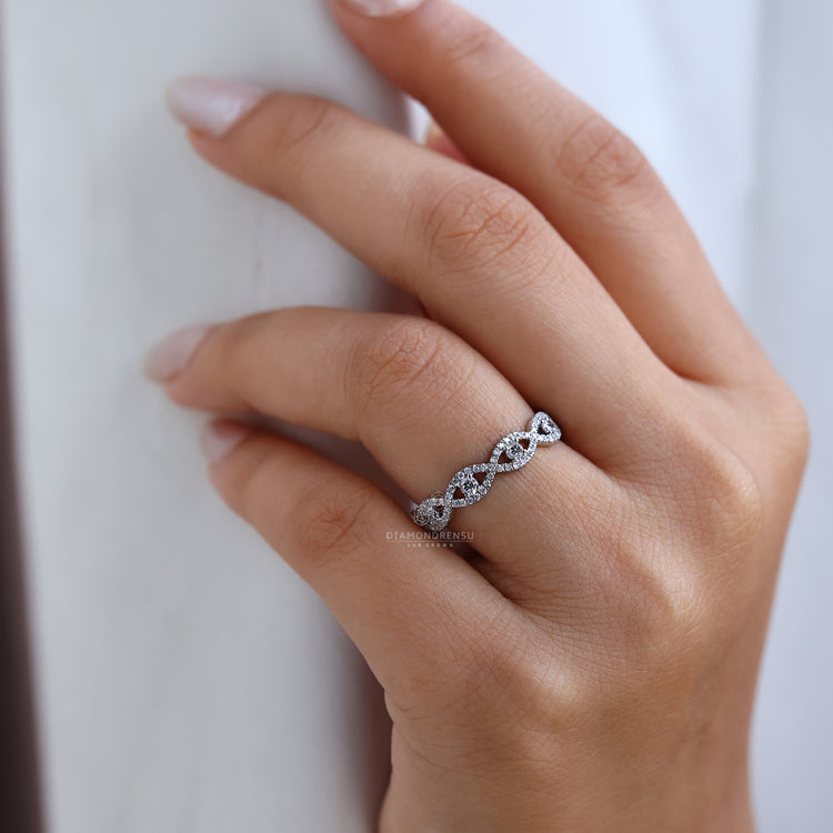 Twist wedding ring with full round diamond setting.